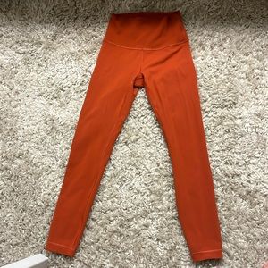 Like new size 4 lululemon dark orange tights.